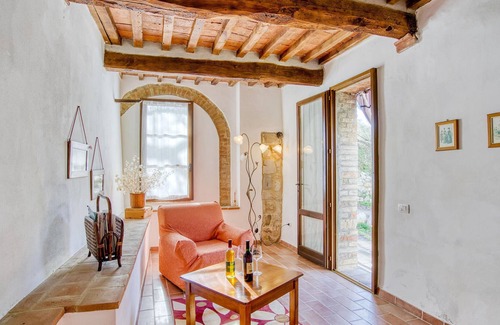 Radicondoli Apartment | Welcome to this charming stone house with shared pool and panoramic views of beautiful surroundings.