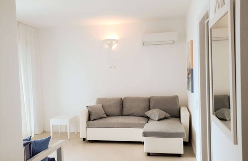 Tinos House | Windmill and houses by the sea // Stavros Bay
