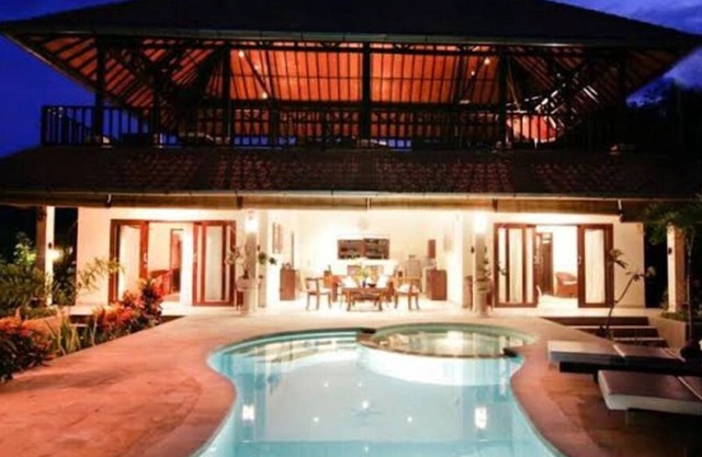 A two story house with a big garden and nice swimming pool.