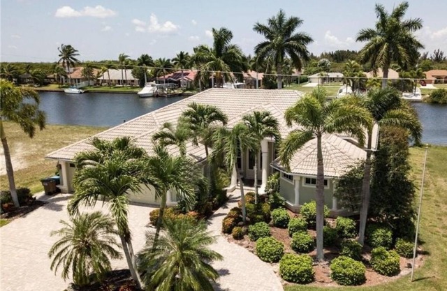 Beautifully maintained 4 bed/2 bath on canal w/pool & sailboat access