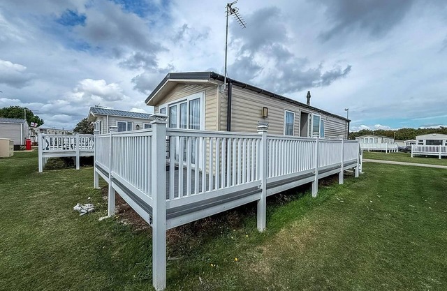 Caravan with large decking at Coopers Beach Holiday Park ref 49012SV
