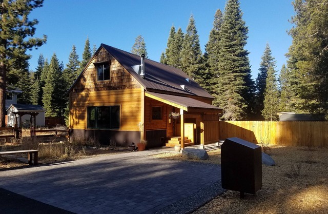 Charming two-story cabin with a private hot tub, patio, & large backyard