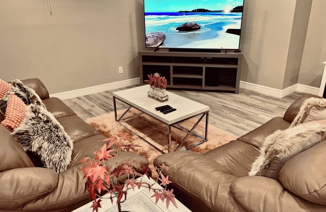 Cozy 2 bedroom basement with 2 beds, kitchen, 75’ TV and bathroom