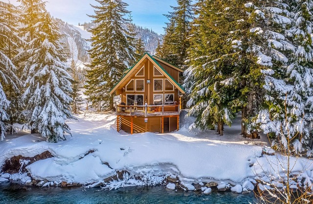 Dog-friendly riverfront cabin with deck, hot tub, gas fireplace, & sauna