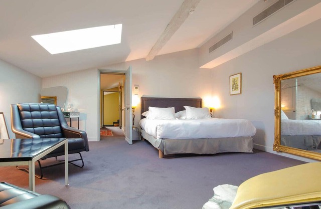 Elegant and warm gray attic suite, decorated with its zebra carpet