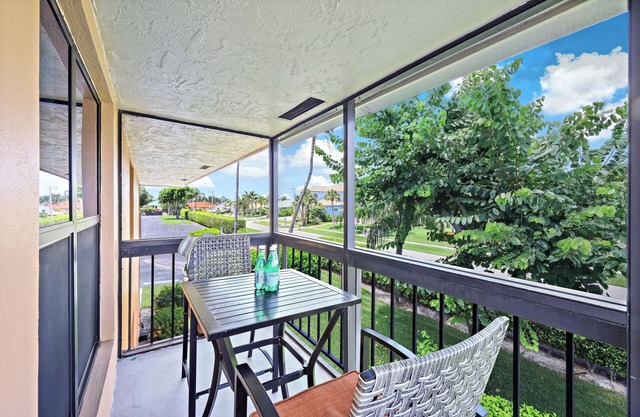 End unit condo w/two pools and steps to beach