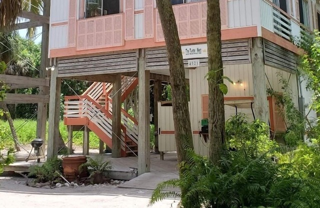 Gorgeously-appointed 4-bedroom beach home steps away from pristine beaches.