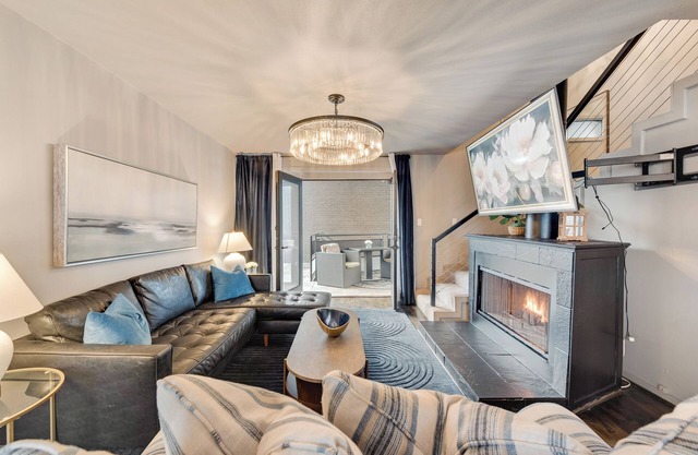 Luxury 3-bed loft featuring king & queen beds, leather sectional, smart TV, resort pool, and private patio access.