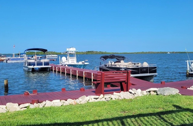 LUXURY 5TH WHEEL WITH FULL DECK directly on the water