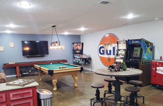 Pinball, pool table, slot machine, shuffleboard, adult drink machines, 65" TV