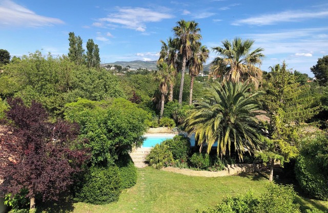 Property with swimming pool, garden and sports field.