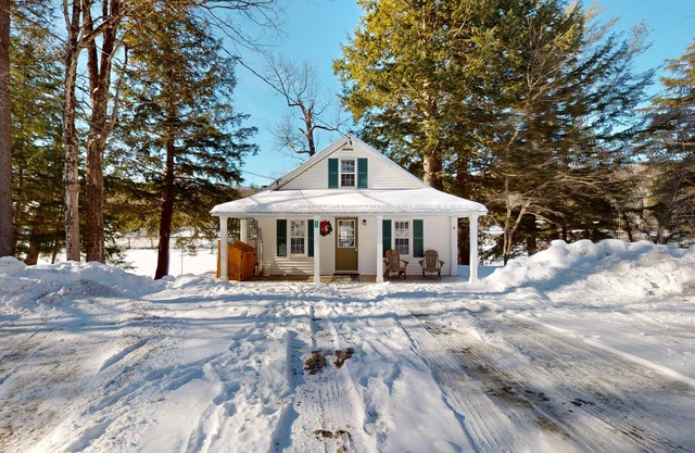 Quaint lakefront home with a fire pit and beautiful views