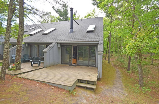Riverfront condo with water views, deck, fireplace, W/D, and community firepit