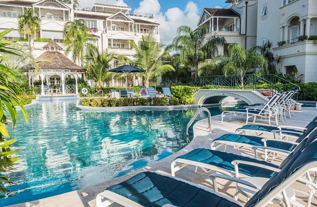 Schooner bay is a beachfront condominium with a freeform swimming pool as the focal point
