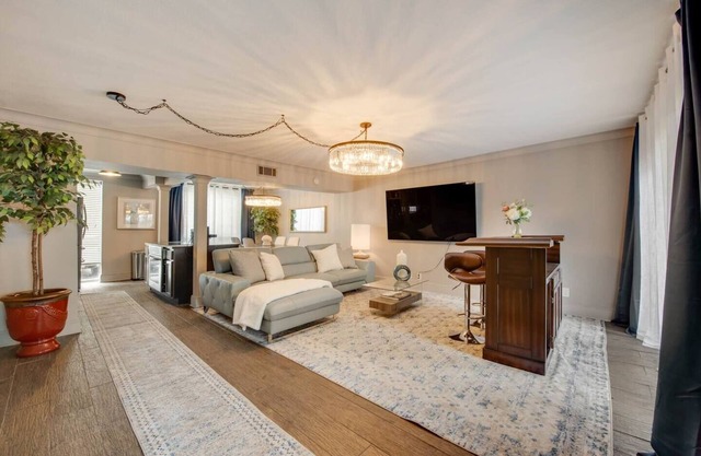 Stylish 2BR condo with pool view, cinematic 77” TV, leather sofa, and access to award-winning courtyard retreat.