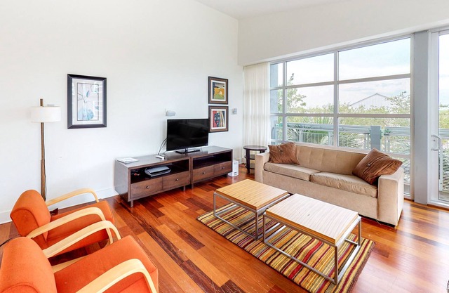Stylish coastal condo w/ shared pool, floor-to-ceiling windows & free WiFi