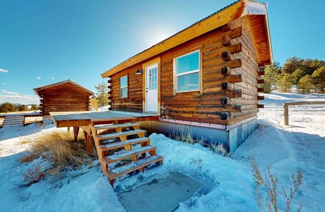 Three log cabins on 1,800-acre ranch with mountain & meadow views