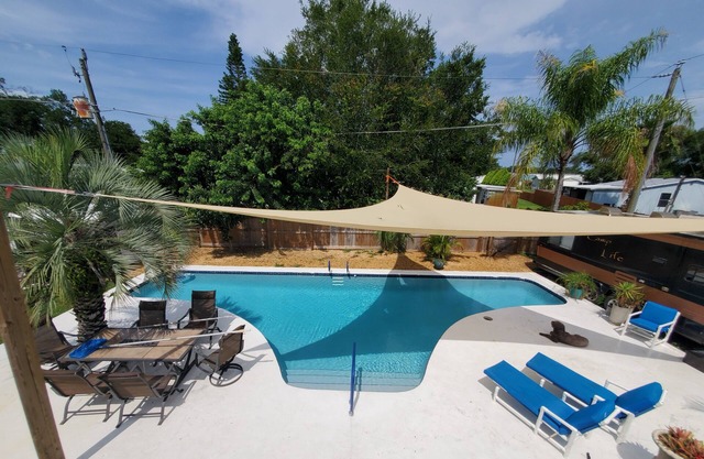 Tropical backyard with pool, sandbox, toys, hammock. Pets+kids welcome