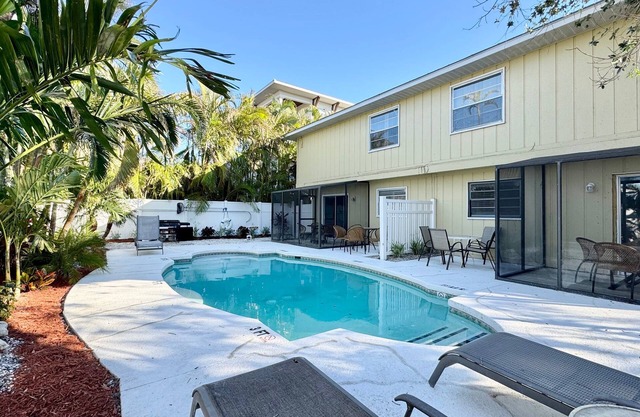 Walk to the Beach and More from this Fully Renovated Unit W/Heated Pool