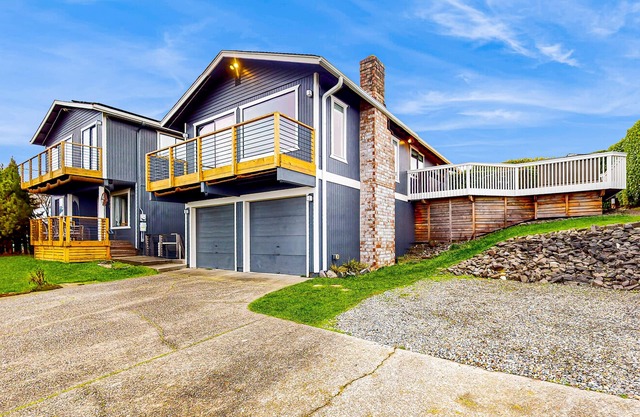 Water-view home with ADU, gated entry, hot tub, enclosed yard, deck, & 2 W/Ds