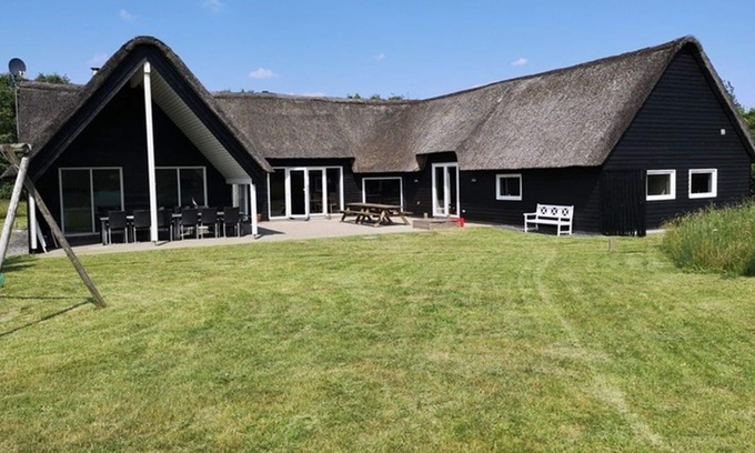 Toftum House | Activity house under thatch with pool, whirlpool, sauna and activity room