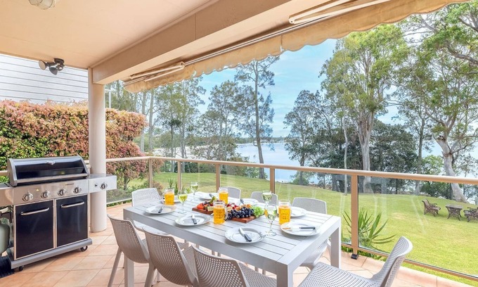 Corlette House | Danalene, 44a Danalene Pde - stunning waterfront property with Air Con, WI-FI, Garage & Boat Parking