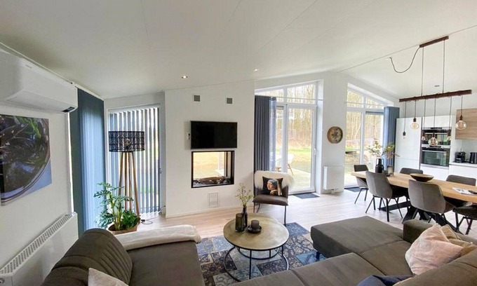 Wemeldinge House | Home with modern interior with air conditioning and view of the forest.