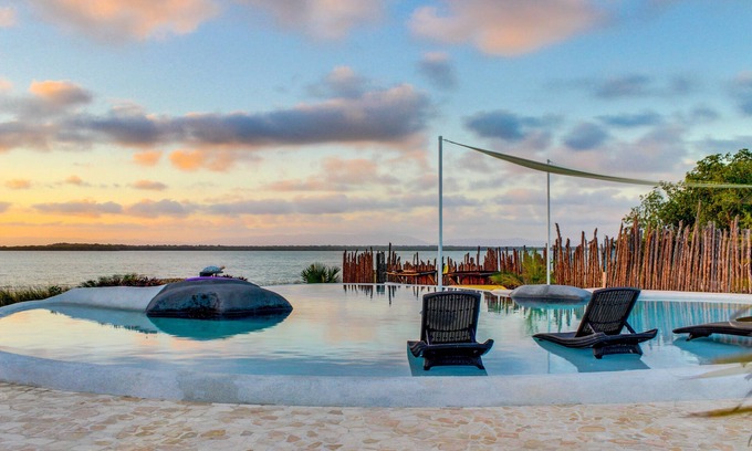 Cocoplum Apartment | Lagoon-front studio with water access, infinity pool, & AC