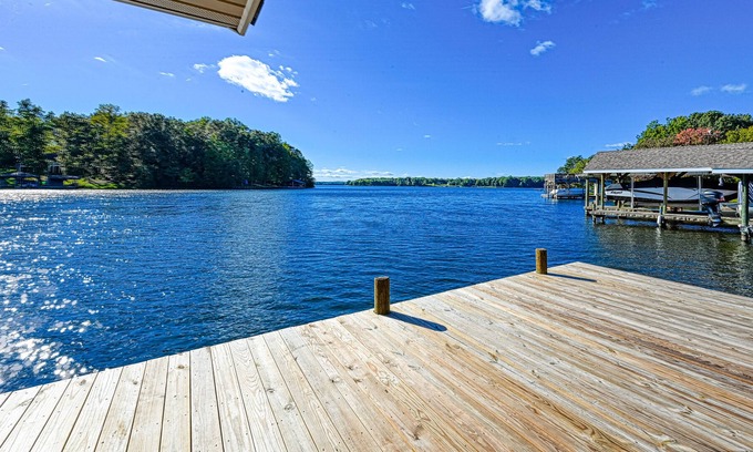 Bumpass House | Lakefront home with spacious deck, dock, game room, hot tub, & sunset views