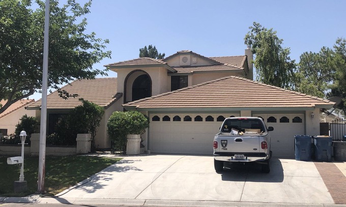 Paradise House | Master Bedroom and bath in a Vegas home with pool & 7 minutes to the stripn