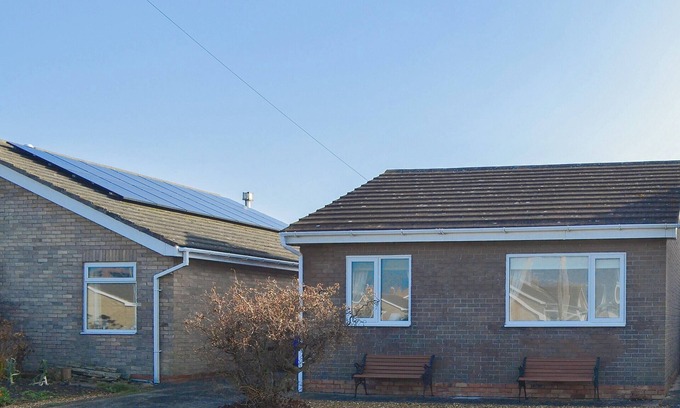 Beadnell Cottage | Modern accommodation with sun room and patio overlooking a small lake.