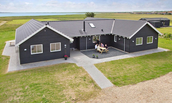 Harboore House | Modern pool house for large group with a view of the Ferringsee