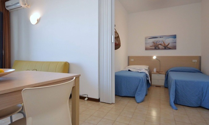 Lignano Sabbiadoro Apartment | Nice apartment for 4 guests with pool, A/C, TV, terrace and pets allowed