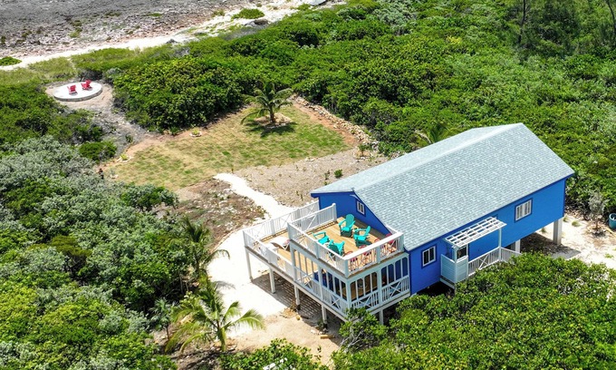Dunmore Town Cottage | Oceanfront Cobalt Cottage- rooftop deck, generator, slide, & daybed swing!