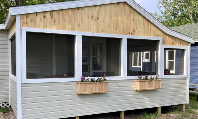 Ludington Cottage | Remodeled lakefront cottage w/marina, firepit, swimming area.