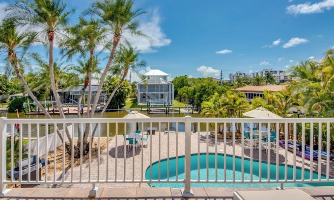 South Island House | Sand Dollar #3 - Upstairs Apt with Shared Pool on Canal by the Beach!