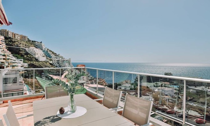 Tabaiba Apartment | Sit back on the terrace and enjoy incredible views of mountains and the ocean beyond. Flooded with natural light, the interior is beautifully curated in a rich beachside palette of pastel hues with nautical touches.
