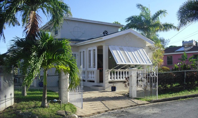 Douglas Villa | Spacious villa with plunge pool in surrounding garden. Palm trees and plants.
