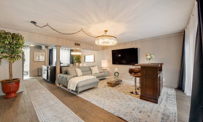 Lower Greenville Condo | Stylish 2BR condo with pool view, cinematic 77” TV, leather sofa, and access to award-winning courtyard retreat.