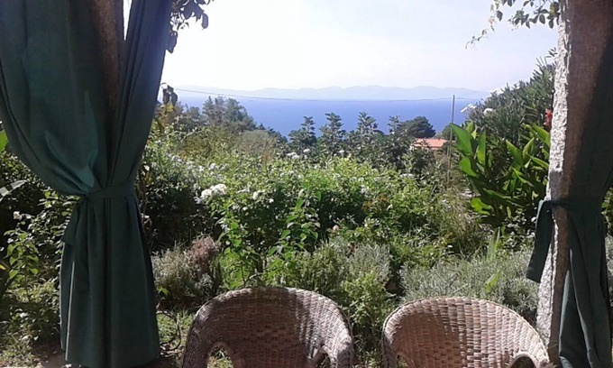 Zanca House | Sunset over Corsica. Detached house surrounded by greenery, sea view.