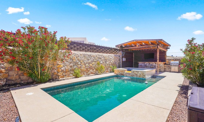 Biggs Field House | This is a true retreat in El Paso with a sparkling pool (w heater), hot tub, and full outdoor entertaining area with a 55" smart TV, tiki bar, and grill.
