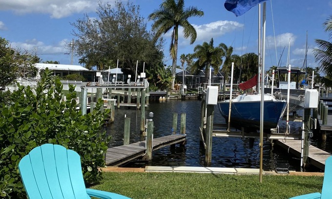 Palm City Cottage | Tropical Getaway! Waterfront Bungalow with Heated Pool, Firepit, & Kayaks