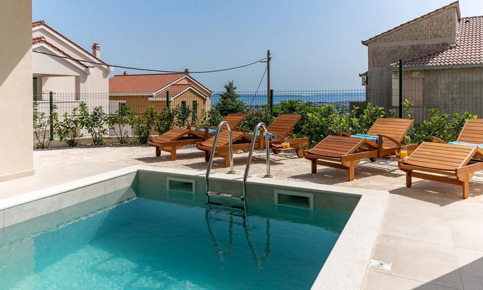 Mravince House | Vacation home with heated pool with covered terrace, stylish interior.