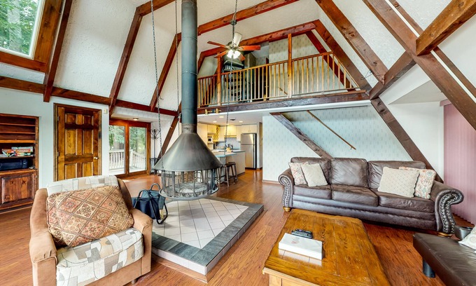 Barnstead House | Waterfront home with wraparound deck, floating fireplace, deck, & firepit
