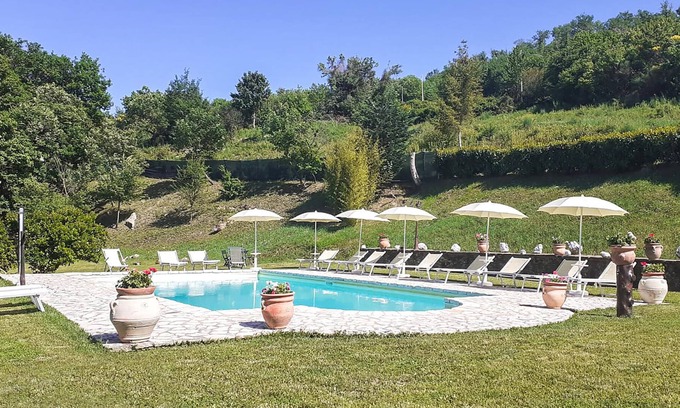 Radicondoli Apartment | Welcome to this charming stone house with shared pool and panoramic views of beautiful surroundings.