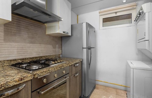 Boegoeroei Condo | Gated community with resort-style amenities - 2 bedroom, 2 bath with an open concept living room and kitchen. Private balcony overlooks pool area.
