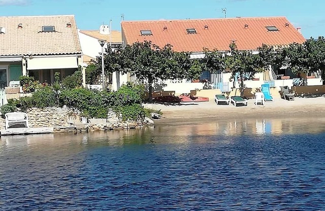 House on the edge of a marine pond close to the beach