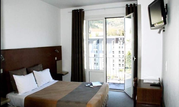 Lourdes Hotel | Enjoy Homelike Comfort & Balcony Sights w/Modern Amenities in Lourdes